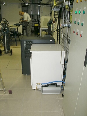 in foreground: nitrogen compressor T11 with the drier, UPS E13